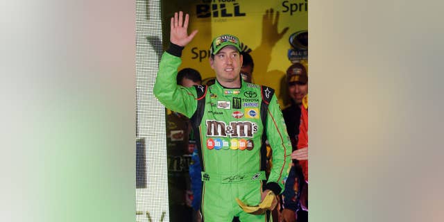 Kyle Busch waves during driver introductions for the NASCAR Sprint All-Star auto race at Charlotte Motor Speedway in Concord, N.C., Saturday, May 16, 2015. (AP Photo/Gerry Broome)