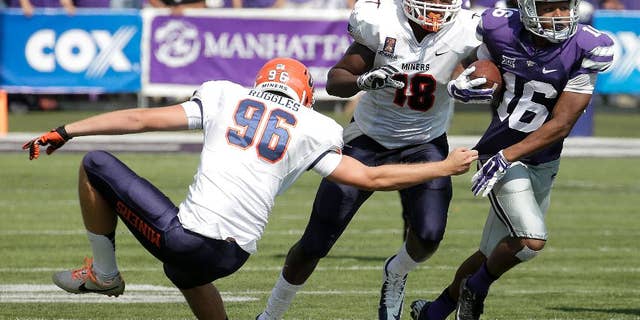Kansas State wide receiver Tyler Lockett (16) gets past UTEP place kicker Mike Ruggles (96) and tight end Katrae Ford (18) as he returns a punt during the first half of an NCAA college football game, Saturday, Sept. 27, 2014, in Manhattan, Kan. (AP Photo/Charlie Riedel)