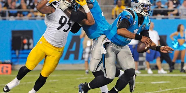 Carolina Panthers' Cam Newton (1) scrambles past Pittsburgh Steelers' Jarvis Jones (95) during the second half of an NFL football game in Charlotte, N.C., Sunday, Sept. 21, 2014. (AP Photo/Mike McCarn)
