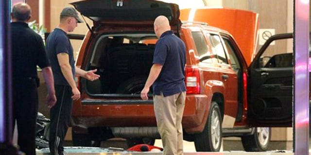 June 8, 2012: FBI investigators and police are on the scene after a sports utility vehicle crashed into an office building at 1050 Connecticut Avenue NW in Washington.