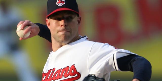 Cleveland Indians starting pitcher Corey Kluber pitches to Seattle Mariners' Austin Jackson during the first inning of a baseball game, Tuesday, June 9, 2015, in Cleveland. (AP Photo/Ron Schwane)
