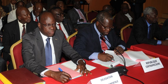 Members of the Central African Republic government delegation await the opening of peace talks with the Seleka rebel alliance, who have taken control of much of the country's north, in Libreville, Gabon, Wednesday, Jan. 9, 2013. Gabon government officials say that talks on the crisis in Central African Republic began Wednesday with representatives of the government, rebels and other groups gathering in this nearby country.(AP Photo/Joel Bouopda Tatou)