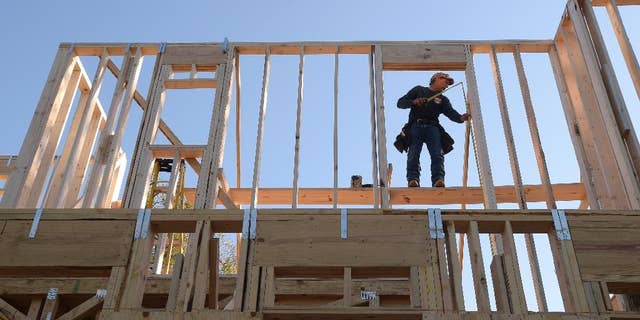 FILE - In this Feb. 13, 2015 file photo, Construction worker David Rager, 53, frames a window in the upper floor of a two-story custom home being built in Orlando, Fla. The Commerce Department releases construction spending for February on Wednesday, April 1, 2015. (AP Photo/Phelan M. Ebenhack, File)