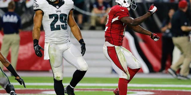 Arizona Cardinals wide receiver John Brown (12) celebrates his touchdown as Philadelphia Eagles strong safety Nate Allen (29) walks away during the second half of an NFL football game, Sunday, Oct. 26, 2014, in Glendale, Ariz. (AP Photo/Rick Scuteri)