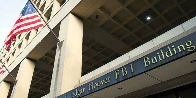 FILE - In this Nov. 2, 2016, file photo, the FBI's J. Edgar Hoover headquarter building in Washington. New documents show the FBI scrambling to respond to Hillary Clinton's lawyers in 2016. (AP Photo/Cliff Owen, File)