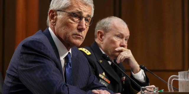 Defense Secretary Chuck Hagel, left, and Army Gen. Martin Dempsey, chairman of the Joint Chiefs of Staff, appear before the Senate Armed Services Committee, the first in a series of high-profile Capitol Hill hearings that will measure the president's ability to rally congressional support for President Barack Obama's strategy to combat Islamic State extremists in Iraq and Syria, in Washington, Tuesday, Sept. 16, 2014. Obama last week outlined his military plan to destroy the extremists, authorizing U.S. airstrikes inside Syria, stepping up attacks in Iraq and deploying additional American troops, with more than 1,000 now advising and assisting Iraqi security forces to counter the terrorism threat. (AP Photo/J. Scott Applewhite)