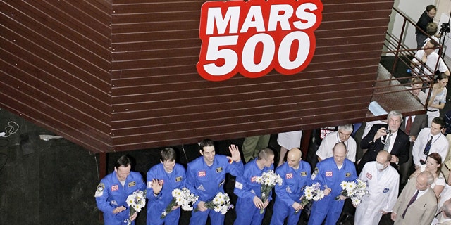 The team of researchers is greeted after ending a three-month simulation mission to Mars at a Moscow research facility, Russia. Another team of researchers will launch a longer, 520-day simulation of Mars mission at the same facility in Moscow on Thursday June 3, 2010.