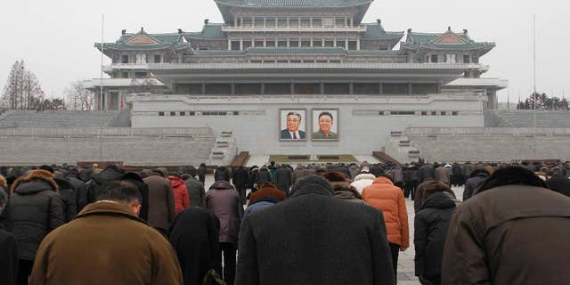 People offer three minutes of silence in front of portraits of the late leaders Kim Il Sung, left, and Kim Jong Il at the Kim Il Sung Square in Pyongyang, North Korea, Saturday, Dec. 17, 2016, to mark the fifth anniversary of Kim Jong Il's death. It’s been five years since North Korean leader Kim Jong Un took power following the death of his father, Kim Jong Il, whose demise was observed at monuments and on city center plazas across the nation Saturday. (AP Photo/Kim Kwang Hyon)