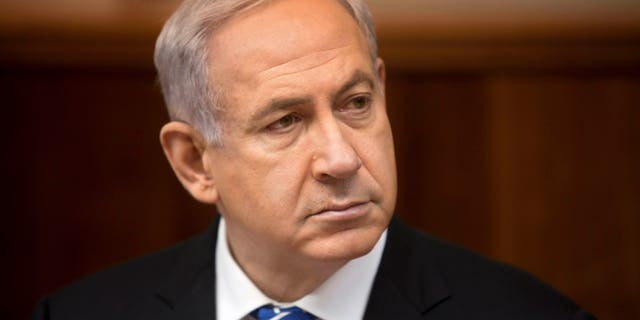 File - In this March 10, 2013 file photo, Israeli Prime Minister Benjamin Netanyahu attends the weekly cabinet meeting in his Jerusalem office. Netanyahu held out the possibility on Thursday, April 18, 2013 of arming Syrian rebels, saying in a televised interview that the decision on whether to intervene in the civil war is a “complicated question” because of the myriad groups taking part in the violence.(AP Photo/Sebastian Scheiner, File)