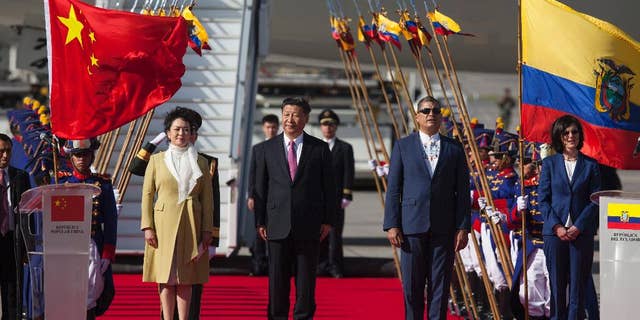 China's President Xi Jinping, center, and his wife Peng Liyuan stand with Ecuador's President Rafael Correa, second from right, during a welcoming ceremony at Mariscal Sucre Airport in Quito, Ecuador, Thursday, Nov. 17, 2016. Xi Jinping is in Ecuador for two days before heading to Peru for the APEC summit. (AP Photo/Ana Buitron)