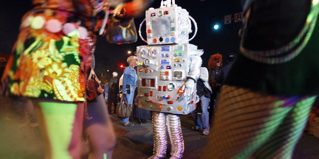 File photo: People in costume dance during the 19th annual Halloween costume carnaval in West Hollywood, California October 31, 2006. (REUTERS/Mario Anzuoni)