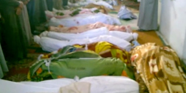 July 13, 2012: This image made from amateur video from Hama Revolution 2011 and accessed by AP video purports to show bodies of victims killed by violence that, according to anti-regime activists, was carried out by government forces in Tremseh, Syria, about nine miles northwest of the central city of Hama.