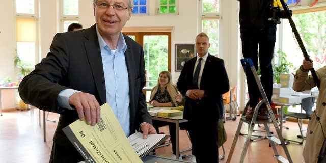 Mayor of Bremen Jens Boehrnsen casts his vote for the state election at a polling station in Bremen, Germany, Sunday, May 10, 2015. Germany's smallest state Bremen has been led by the center-left Social Democrats since the 1940s and polls point to a majority for popular Mayor Boehrnsen's current coalition with the Greens in the regional legislature. (Ingo Wagner/dpa via AP)