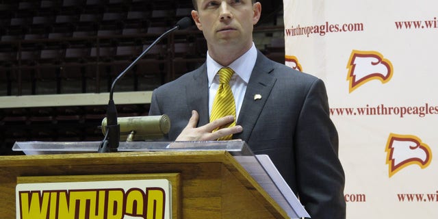 FILE - In this April 5, 2012 file photo, Pat Kelsey speaks to fans as he is introduced as the new Winthrop men's basketball coach during a news conference at the Winthrop Coliseum in Rock Hill, S.C. A short time after her 7-year-old son, Chase, died in the Newtown, Conn., shootings at Sandy Hook Elementary, Becky Kowalski watched video of Winthrop basketball coach Pat Kelsey's heartfelt words about the tragedy. "He gets it," she said at the time. "He understands." The Kowalski family will meet Kelsey this week when they attend Winthrop's home game with Presbyterian on Saturday, March 1, 2014. (AP Photo/Jeffrey Collins, File)