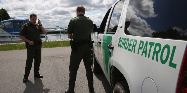 BEAVER ISLAND STATE PARK, NY - JUNE 03: U.S. Border Patrol agents talk while at a marina on the Niagara River at the U.S.-Canada border on June 3, 2013 in Beaver Island State Park, New York. U.S. Customs and Border Protection, which includes the Border Patrol, monitors the 5,525 mile long border, including Alaska, forming the longest international border between two countries in the world.  (Photo by John Moore/Getty Images)