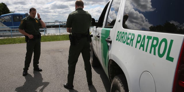 BEAVER ISLAND STATE PARK, NY - JUNE 03: U.S. Border Patrol agents talk while at a marina on the Niagara River at the U.S.-Canada border on June 3, 2013 in Beaver Island State Park, New York. U.S. Customs and Border Protection, which includes the Border Patrol, monitors the 5,525 mile long border, including Alaska, forming the longest international border between two countries in the world. (Photo by John Moore/Getty Images)