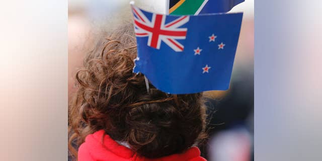 A rugby fan wears a New Zealand flag in her hair in October.