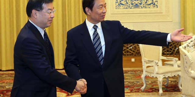 In this photo provided by China's Xinhua News Agency, Chinese Vice President Li Yuanchao, right, meets with President of Japan's National Governors' Association, Keiji Yamada, in Beijing, capital of China, Tuesday, Oct. 28, 2014. China's vice president met Tuesday with a delegation of governors from Japan amid strained bilateral ties, a rare high-level meeting that points to Japan's hopes of a summit between the two countries' leaders at a regional conference next month. (AP Photo/Xinhua, Liu Weibing) NO SALES
