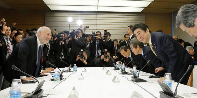 In this March 16, 2016 photo, Japanese Prime Minister Shinzo Abe, second from right, and Nobel laureate economist Joseph Stiglitz, left, take their seats for an economic seminar with other members of his Cabinet at Abe's official residence in Tokyo. The message: no matter how bad the debt, Japan's economy is too weak to withstand another tax hike. All is not well in Abenomics land, the world’s third-largest economy, and Abe is seeking fresh advice from top experts, both foreign and Japanese, on what to do next. (Kazunari Fujikake/Kyodo News via AP) JAPAN OUT, MANDATORY CREDIT