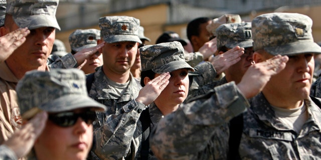 FILE: Nov. 11, 2008: US soldiers of Combined Security Transition Command salute during a Veterans Day ceremony in Kabul, Afghanistan.