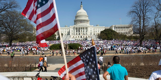 A crowd fills the lawn on Capitol Hill in Washington, Wednesday, April 10, 2103, during the "Rally for Citizenship," where tens of thousands of immigrants and their supporters were expected to rally for immigration reform. Bipartisan groups in the House and Senate are said to be completing immigration bills that include a pathway to citizenship for the nation's 11 million immigrants with illegal status. (AP Photo/Jacquelyn Martin)