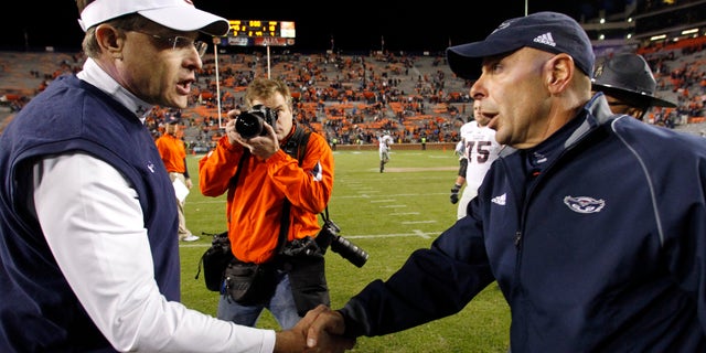 Auburn head coach Gus Malzahn, left, shakes hands with Florida Atlantic head coach Carl Pelini after defeating them 45-10 in an NCAA college football game on Saturday, Oct. 26, 2013, in Auburn, Ala. (AP Photo/Butch Dill)