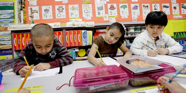 In this photo made Tuesday, Feb. 15, 2011, five-year-old kindergarden students Gael Alvarado, left, Perla Ortiz, center, and Yahir Perez do school work in a bilingual english-spanish class at Hanby Elementary School in Mesquite, Texas. Mesquite ISD, like many districts in Texas, has seen a demographic shift in the racial make up students over the past 10 years. Hispanics account for two-thirds of Texas' growth over the past decade and now make up 38 percent of the state's total population, according to new local U.S. Census figures released Thursday, Feb. 17, 2011. (AP Photo/LM Otero) (AP Photo/LM Otero)