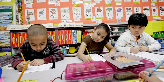 In this photo made Tuesday, Feb. 15, 2011, five-year-old kindergarden students Gael Alvarado, left, Perla Ortiz, center, and Yahir Perez do school work in a bilingual english-spanish class at Hanby Elementary School in Mesquite, Texas. Mesquite ISD, like many districts in Texas, has seen a demographic shift in the racial make up students over the past 10 years. Hispanics account for two-thirds of Texas' growth over the past decade and now make up 38 percent of the state's total population, according to new local U.S. Census figures released Thursday, Feb. 17, 2011. (AP Photo/LM Otero) (AP Photo/LM Otero)