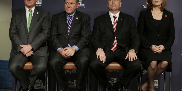 Notre Dame athletic director Jack Swarbrick, left, and head football coach Brian Kelly, second from left, along with Rutgers athletic director Julie Hermann, right, and head football coach Kyle Flood, attend an NCAA college football news conference in New York, Tuesday, Dec. 10, 2013. Rutgers and Notre Dame will face off at the Pinstripe Bowl at Yankee Stadium on Saturday, Dec. 28, 2013. (AP Photo/Seth Wenig)