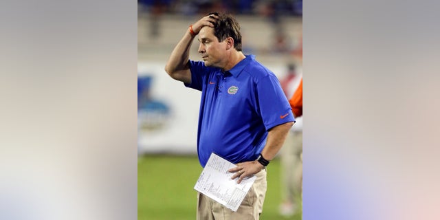 Florida head coach Will Muschamp holds his hand on his head as he watches the final moments of an NCAA college football game against Georgia in Jacksonville, Fla., Saturday, Nov. 2, 2013. Georgia won the game 23-20. (AP Photo/John Raoux)