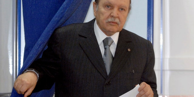 FILE - This May, 10, 2012 file photo shows Algerian President Abdelaziz Bouteflika exiting a parliamentary election voting booth in Algiers. Algeria's presidency says the country's ailing president has been in a Paris military hospital since Monday for a routine checkup and his condition is improving. Abdelaziz Bouteflika suffered a stroke in April and was hospitalized for four months in Paris' Val-de-Grace hospital. He has seemed visibly weak in rare television appearances since then. (AP Photo/Sidali Djarboub, File)