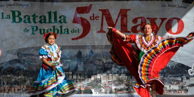 LOS ANGELES, CA - MAY 05: Aracely Saucillo (L) and Marylin Castillo perform with Mexica Ballet Folclorico performs during Cinco De Mayo festivities on May 5, 2011 at El Pueblo de Los Angeles Historic Site on Olvera Street in downtown Los Angeles, California. Cinco de Mayo celebrates the 1862 Mexican victory over the French in the Battle of Puebla. (Photo by Kevork Djansezian/Getty Images)