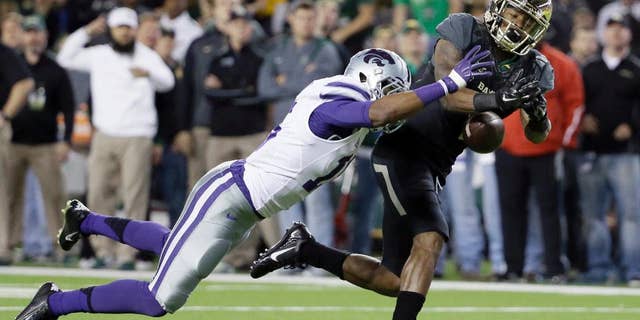 Kansas State defensive back Randall Evans (15) breaks up a pass intended for Baylor's Corey Coleman (1) in the first half of an NCAA college football game, Saturday, Dec. 6, 2014, in Waco, Texas. (AP Photo/Tony Gutierrez)