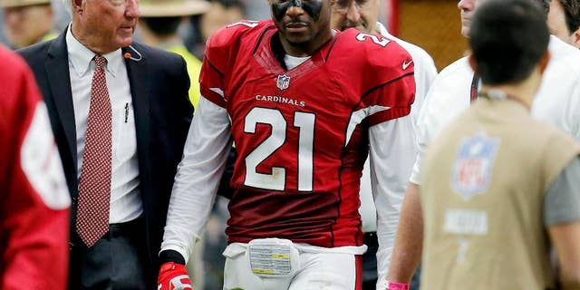 Arizona Cardinals cornerback Patrick Peterson (21) is helped off the field after being injured against the Philadelphia Eagles during the first half of an NFL football game, Sunday, Oct. 26, 2014, in Glendale, Ariz. (AP Photo/Rick Scuteri)