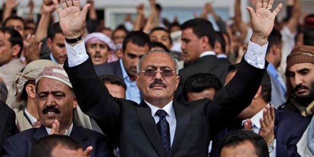 In this April 15, 2011, file photo Yemeni President Ali Abdullah Saleh waves to his supporters during a rally in Sanaa, Yemen. The head of a coalition of Gulf countries seeking to broker an end to Yemen's political crisis gave up on Wednesday and left the country, opposition and government leaders said. Yemen is reeling from three months of massive street protests demanding the ouster of President Ali Abdullah Saleh after more than three decades in power. (AP/File)