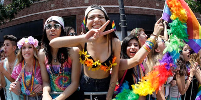 In this June 28, 2015 file photo, people smile and gesture during the annual Chicago Pride Parade in Chicago.