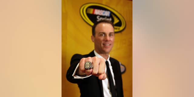 Kevin Harvick poses with his championship ring during the NASCAR Sprint Cup Series auto racing awards at Wynn Las Vegas Friday, Dec. 5, 2014, in Las Vegas. (AP Photo/Isaac Brekken)