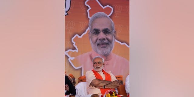 Gujarat state chief minister and Bharatiya Janata Party's prime ministerial candidate Narendra Modi sits during party workers' convention after inaugurating the party's new state headquarters building in Gandhinagar, India, Monday, Feb. 10, 2014. (AP Photo/Ajit Solanki)