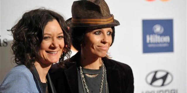 FILE - In this Feb. 9, 2013 file photo, actress Sara Gilbert, left, and recording artist Linda Perry arrive at the Clive Davis Pre-GRAMMY Gala in Beverly Hills, Calif. A spokeswoman for Gilbert says the actress and musician were wed over the weekend. Melissa Kates confirmed the nuptials Monday, March 31, 2014. (Photo by John Shearer/Invision/AP, file)