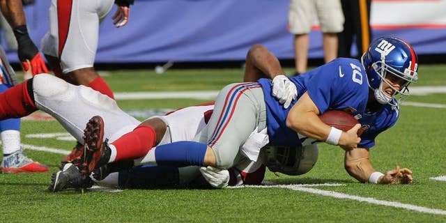 New York Giants quarterback Eli Manning (10) is sacked by Arizona Cardinals defensive end Calais Campbell during the second half of an NFL football game Sunday, Sept. 14, 2014, in East Rutherford, N.J. The Cardinals won the game 25-14. (AP Photo/Kathy Willens)