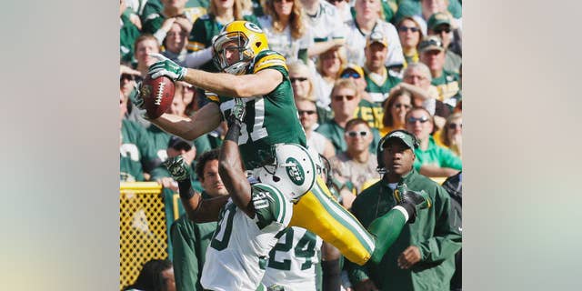 New York Jets fans react after a touchdown catch was called back because the team called a time out before the ball was snapped during the second half of an NFL football game against the Green Bay Packers Sunday, Sept. 14, 2014, in Green Bay, Wis. (AP Photo/Mike Roemer)