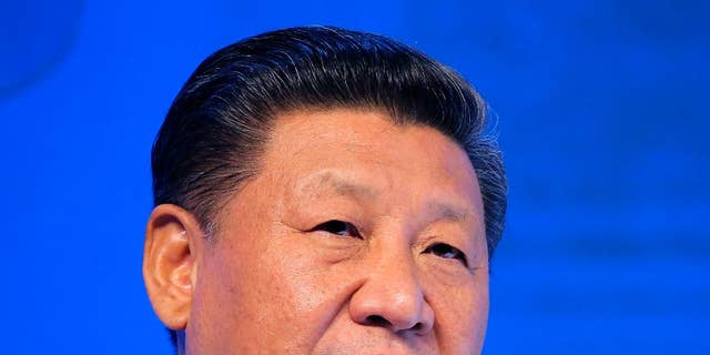 FILE - In this  Jan. 17, 2017, file photo, Chinese President Xi Jinping speaks at the World Economic Forum in Davos, Switzerland. U.S. President Donald Trump has reaffirmed America’s long-standing “one China” policy in a telephone conversation with Xi that could alleviate concerns about a major shift in Washington’s approach to relations with Beijing. The long-awaited call came Thursday, Feb. 9, 2017, Washington time, the White House and China’s state broadcaster CCTV said. (AP Photo/Michel Euler, File)