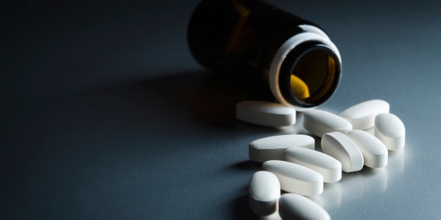medical bottle and pills on background