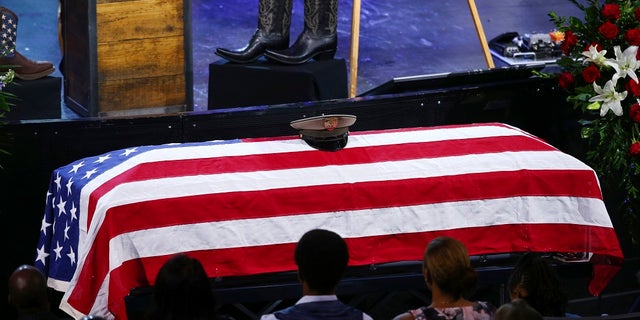 Family members listen during a funeral for Las Vegas police officer Charleston Hartfield.