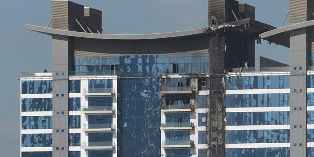 The burned elevation of one of the towers at the Oceana complex is seen in Dubai, United Arab Emirates, Tuesday, Dec. 13, 2016. Firefighters in Dubai have put out a fire that broke out on one of Dubai's palm-shaped island, the latest in a string of blazes to race up multi-story buildings in the skyscraper-packed city. Dubai's government media office said Tuesday that the late-night fire was completely extinguished with no injuries reported. (AP Photo/Kamran Jebreili)
