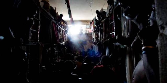 Prisoners rest in makeshift hammocks inside the National Penitentiary in downtown Port-au-Prince, Haiti.