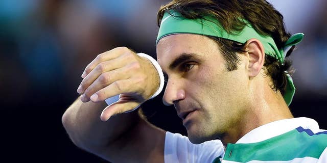 FILE- In this Thursday, Jan. 28, 2016 file photo, Roger Federer of Switzerland wipes the sweat from his face during his semifinal match against Novak Djokovic of Serbia at the Australian Open tennis championships in Melbourne, Australia. Swiss star Roger Federer has pulled out of the French Open because of concerns over the risk of injury. (AP Photo/Andrew Brownbill, File)