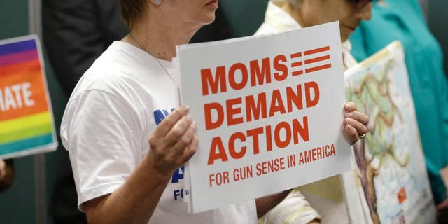 Kathryn Reeve, with the group Moms Demand Action, left, listens during a news conference, Tuesday, July 5, 2016, in Fort Lauderdale, Fla., where Congresswoman Debbie Wasserman Schultz, D-Fla. and other community leaders demanded action by House Speaker Paul Ryan to allow a vote on gun legislation.  The House won't vote on proposed Democratic gun curbs, Speaker Paul Ryan suggested Tuesday as the rekindled election-year clash over firearms showed no sign of resolution.   (AP Photo/Lynne Sladky)