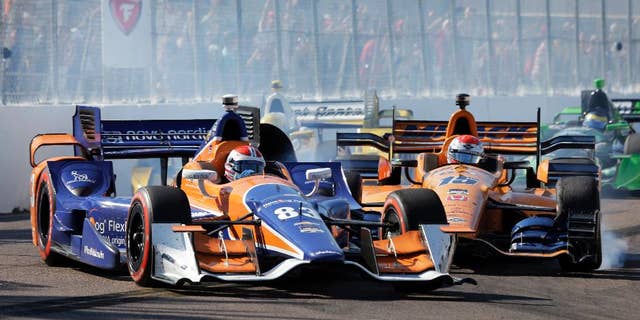 Charlie Kimball (83) gets hit by Graham Rahal while driving into Turn 10 during the IndyCar Firestone Grand Prix of St. Petersburg auto race Sunday, March 29, 2015, in St. Petersburg, Fla. (AP Photo/Chris O'Meara)