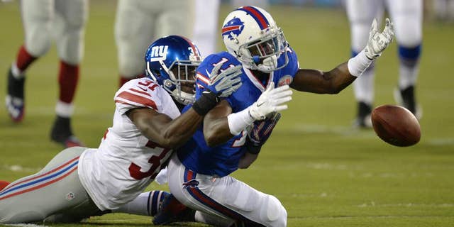 Buffalo Bills wide receiver T.J. Graham (11) can't reach the ball on a pass under pressure from New York Giants cornerback Zack Bowman (31) in the second quarter of the Pro Football Hall of Fame exhibition NFL football game Sunday, Aug. 3, 2014, in Canton, Ohio. (AP Photo/David Richard)